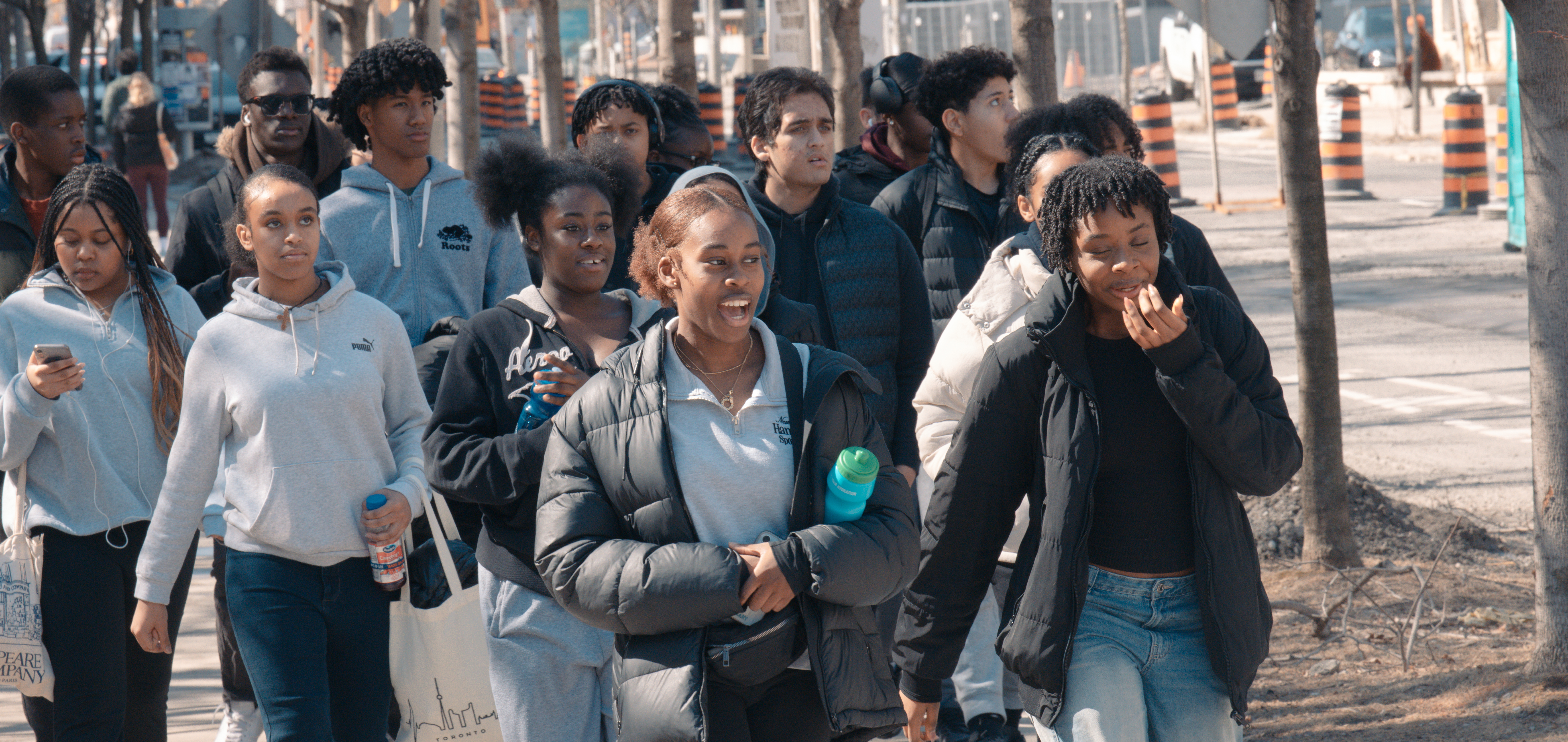 Reach Ahead students smile and laugh while walking outside on the St. George campus during spring 2025