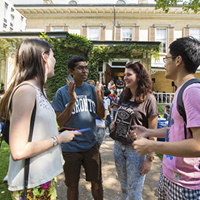 four students outside in conversation