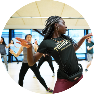 darker skinned girl with braids leading a dance class