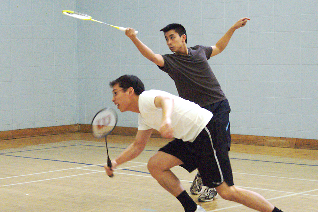 two young men playing badminton
