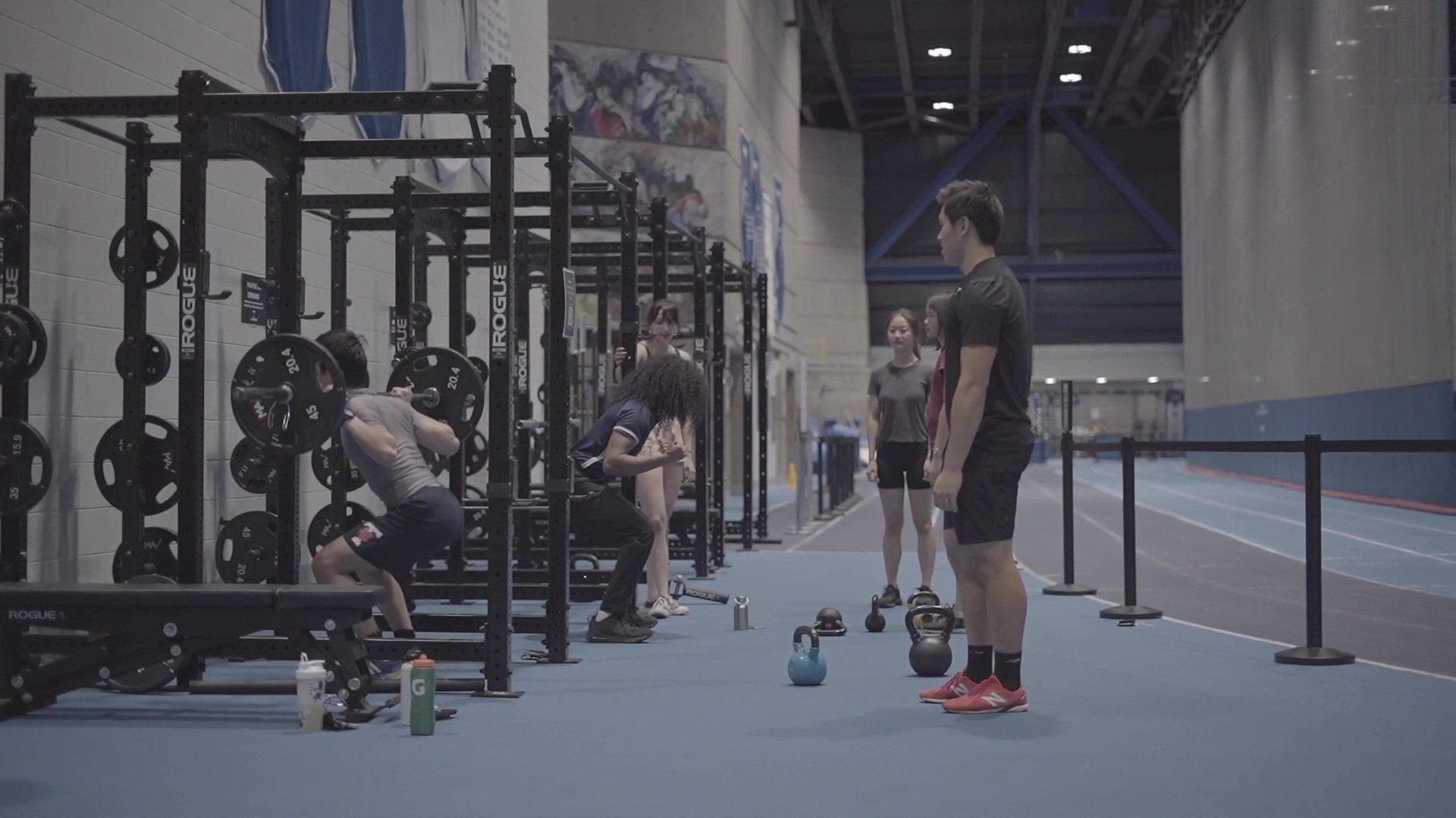 image of participant group around squat racks in Field House
