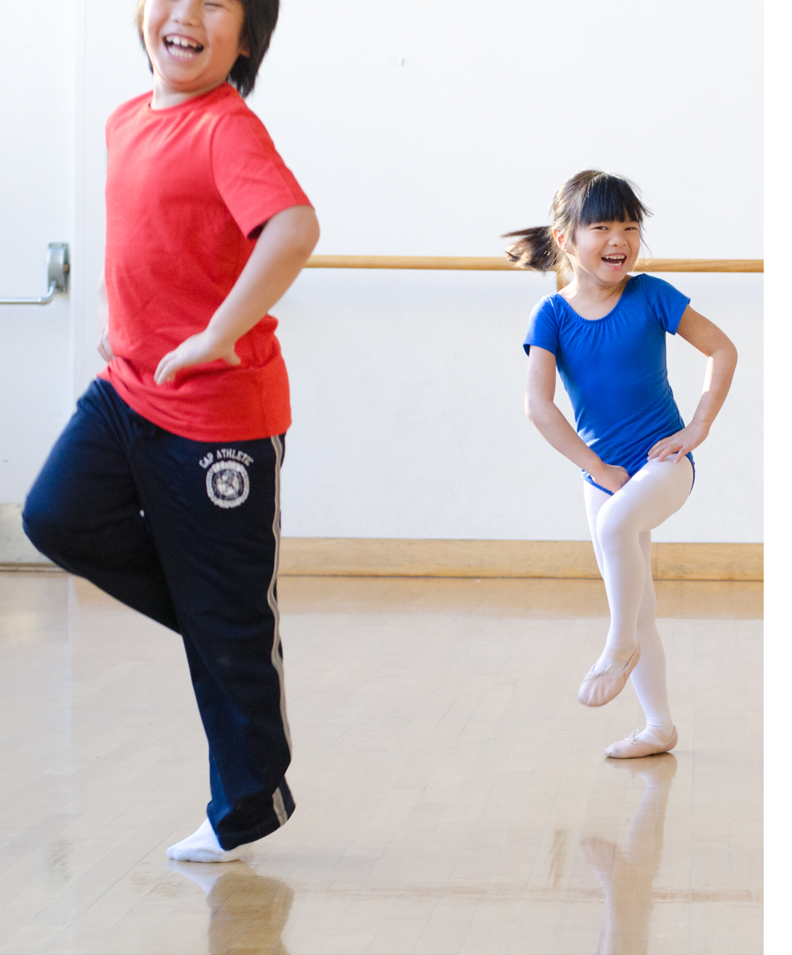 two Asian children dancing in gym