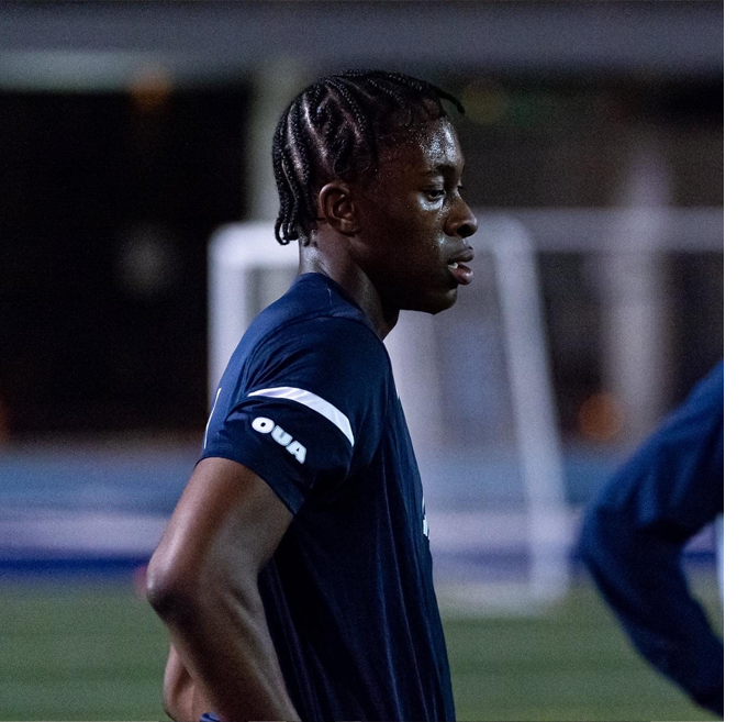 kingsley with hands on hips on soccer field