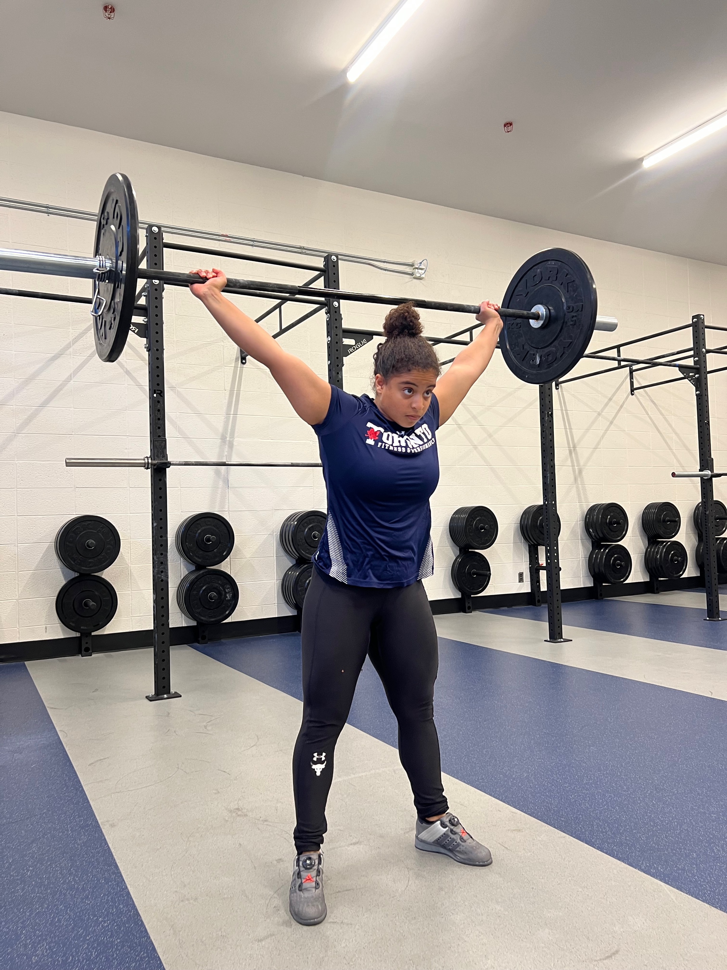 Women lifting barbell overhead