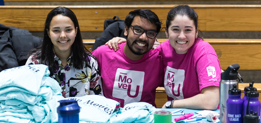 Three MoveU crew members at an event