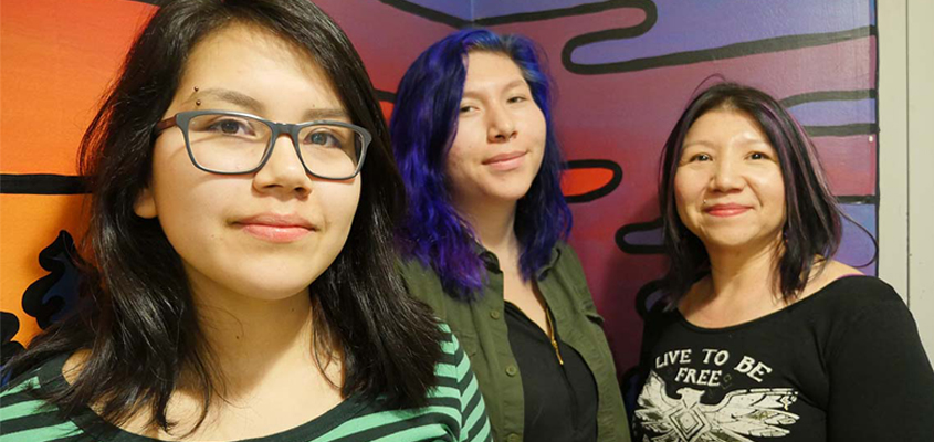 Pair of Indigenous high school students with adult chaperone