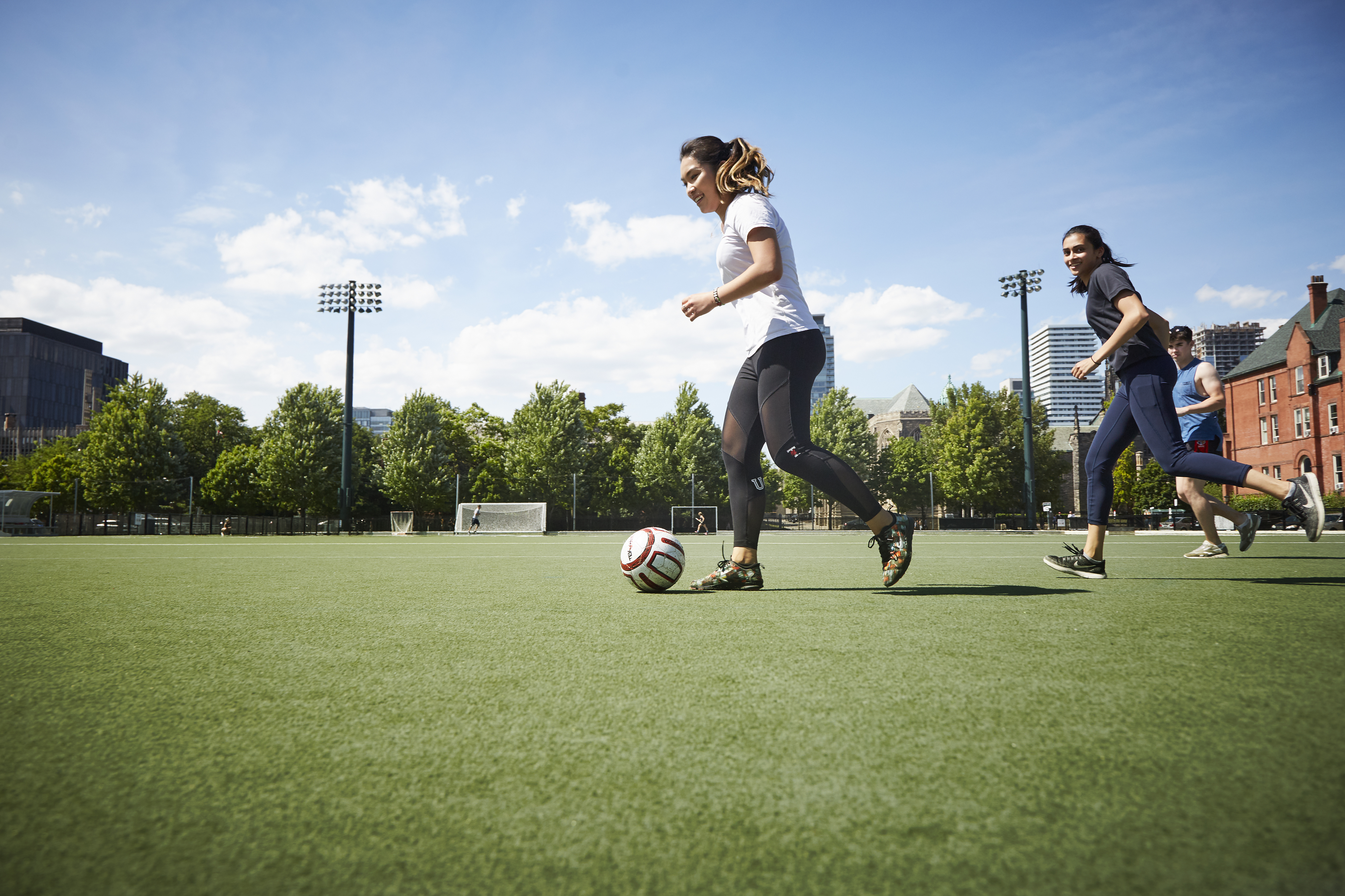 two women playing soccer at Back Campus Field