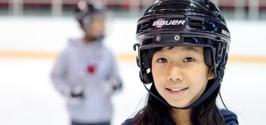 young girl with a black hocket helmet 