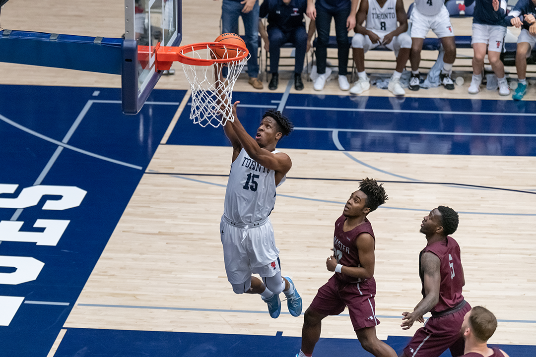 varsity basketball athlete dunking 