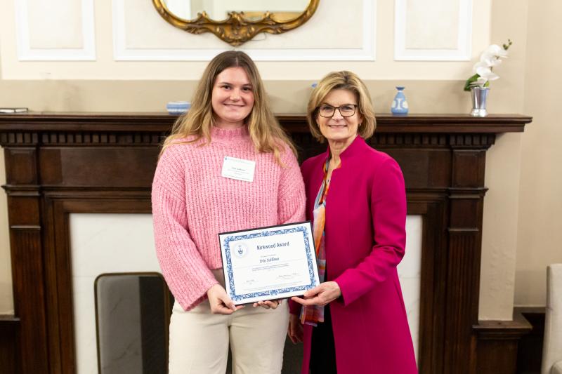Erin Sullivan poses with Dean Gretchen Kerr and her Kirkwood Award in front of the Arts & Letters Club fireplace