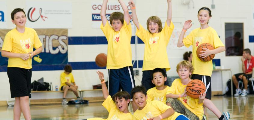 A group of boys pose with basketballs 