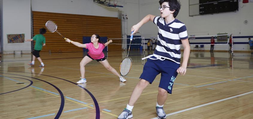 Two youngsters play mixed doubles