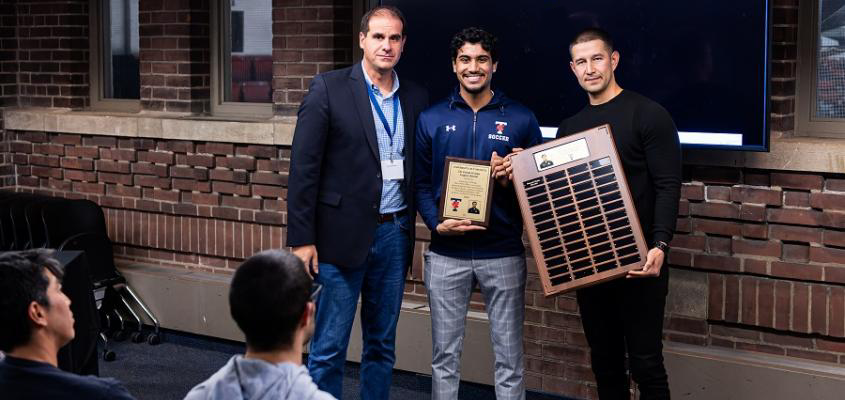 Anthony Capotosto, former head coach of the U of T Varsity Blues soccer team, left, and Ilya Orlov, present head coach of the team, right, flank Naseeb Bains, the inaugural recipient of the Dr. Guido Geisler scholarship 