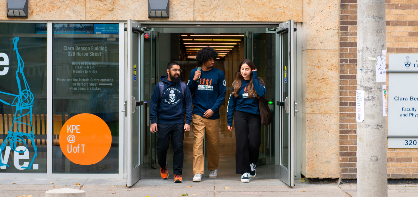 three student ambassadors exiting Clara Benson building