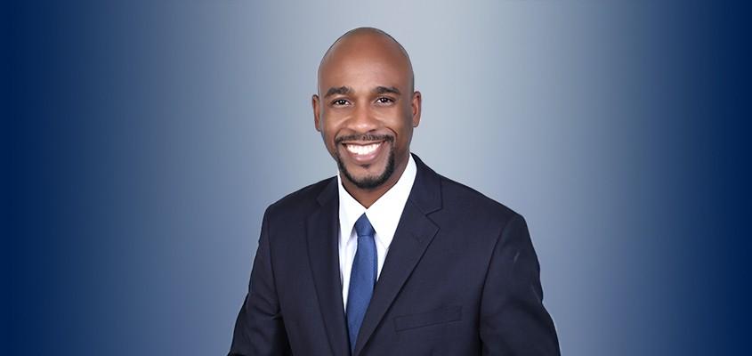 Dalton Myers smiling in image with a blue backdrop