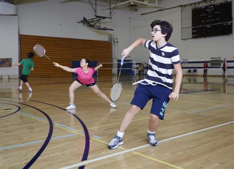 Two youngsters play mixed doubles