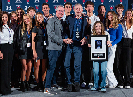 A photograph of the Kimel family holding with Ron Kimel in centre holding his Sports Hall of Fame award
